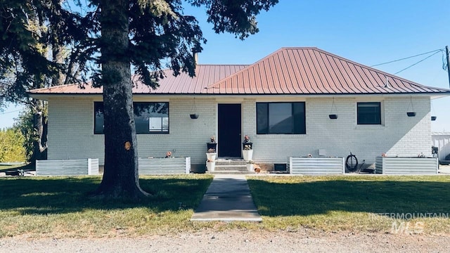 4 N 1050 E, Declo, ID 83323 - ranch-style house with a front lawn, metal roof, and brick siding