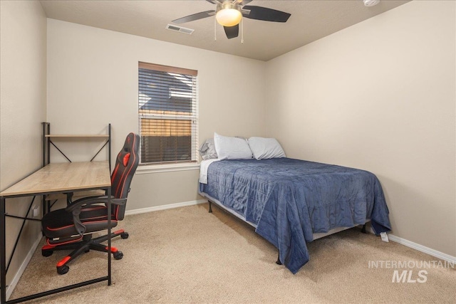 carpeted bedroom featuring ceiling fan, visible vents, and baseboards