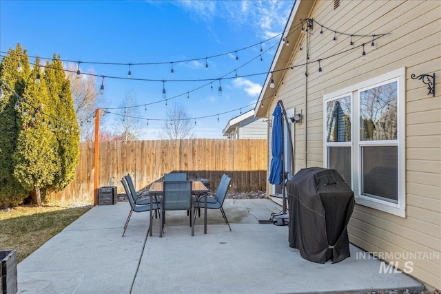 view of patio / terrace with outdoor dining area, area for grilling, and fence