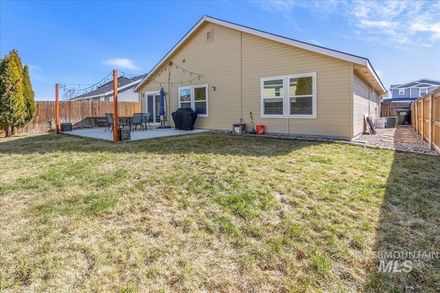 back of property featuring a patio, a lawn, and a fenced backyard