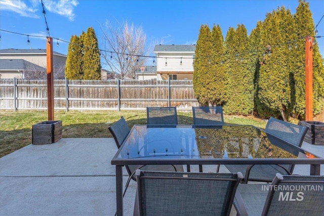 view of patio featuring outdoor dining area and fence