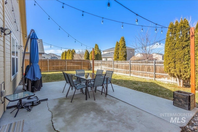 view of patio with outdoor dining space and a fenced backyard