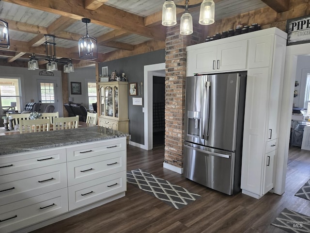 kitchen featuring stainless steel refrigerator with ice dispenser, baseboards, light stone counters, and dark wood-style flooring