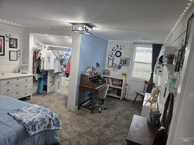 carpeted bedroom with a spacious closet