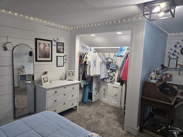 bedroom with dark carpet and a textured ceiling
