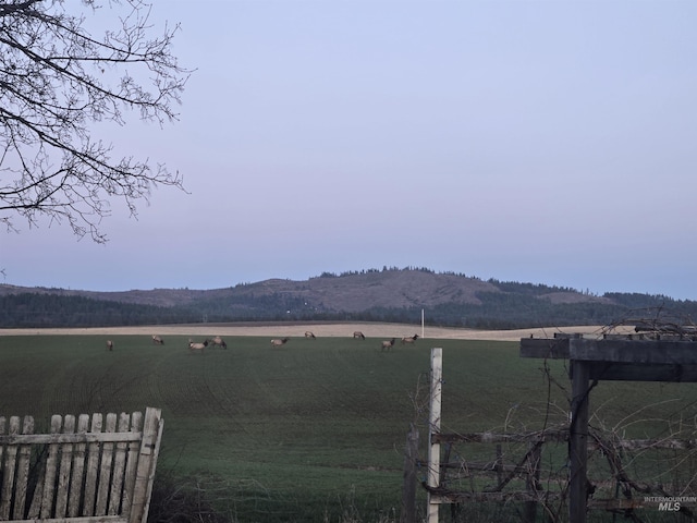 exterior space featuring fence and a mountain view