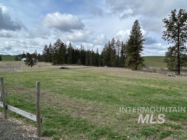 view of yard featuring fence and a rural view