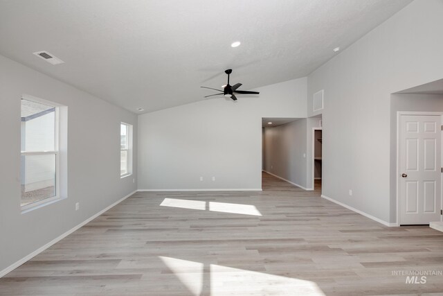 unfurnished room with ceiling fan, vaulted ceiling, and light hardwood / wood-style flooring
