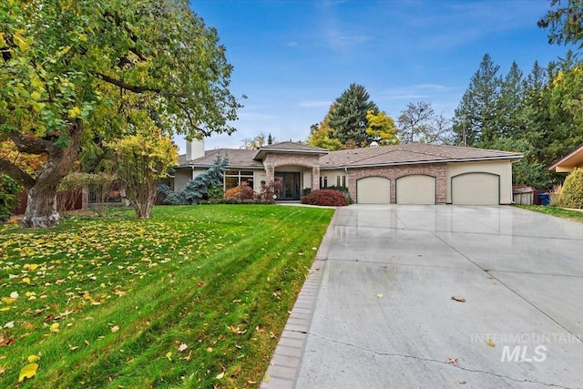 view of front of house featuring a garage and a front lawn