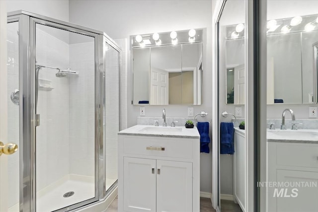 bathroom with vanity and a shower with door