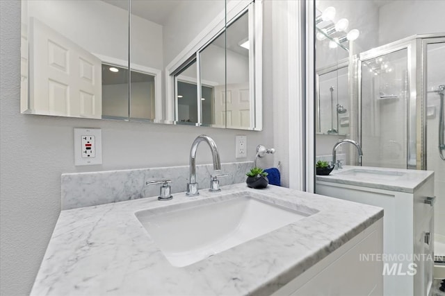 bathroom featuring vanity and an enclosed shower