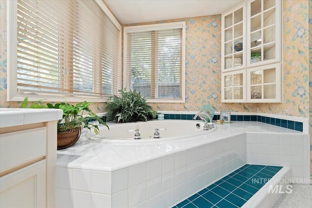 bathroom with a relaxing tiled tub