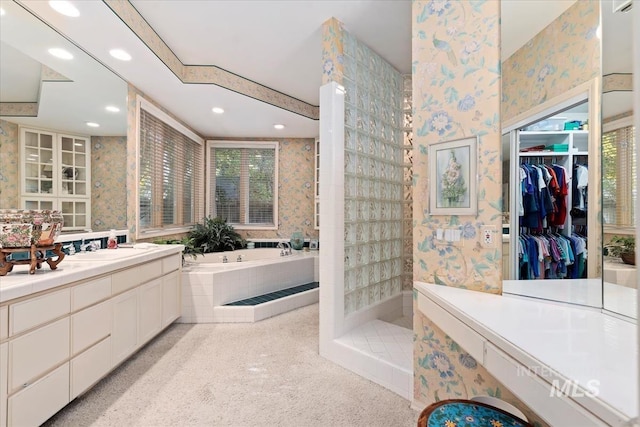 bathroom with shower with separate bathtub and vanity