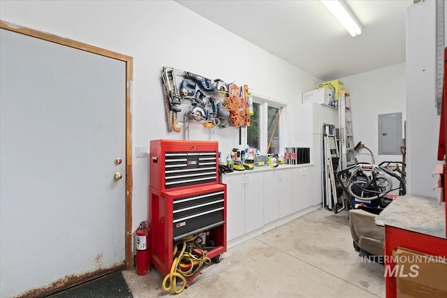 garage featuring a workshop area and electric panel