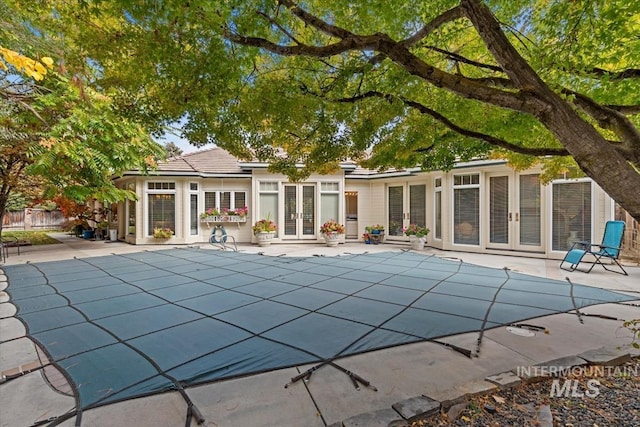 view of pool featuring a patio area and french doors