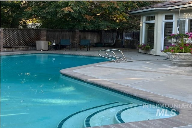 view of swimming pool with a patio