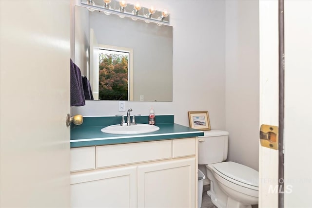 bathroom featuring vanity and toilet