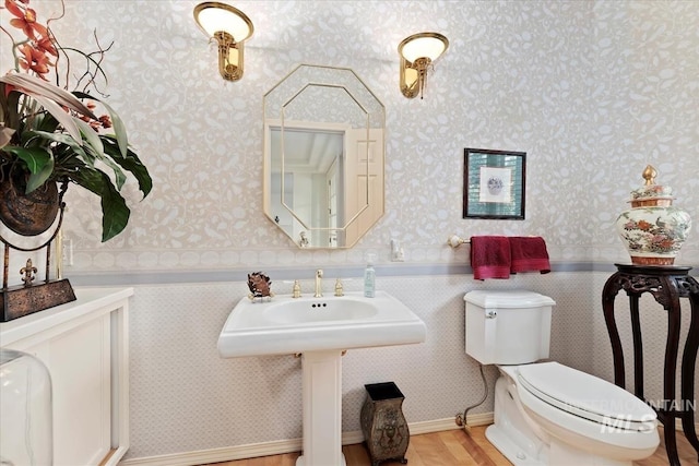 bathroom featuring wood-type flooring and toilet