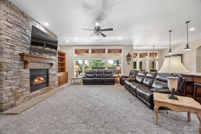 1573 E Commander St, Meridian, ID 83646 - carpeted living room with a fireplace, a textured ceiling, ceiling fan, and recessed lighting