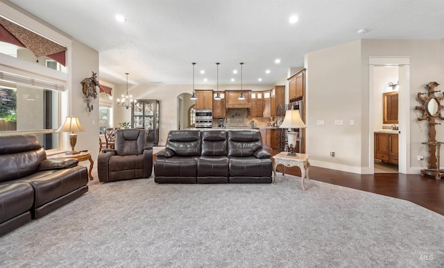 1573 E Commander St, Meridian, ID 83646 - living room with a chandelier, recessed lighting, dark colored carpet, arched walkways, and baseboards