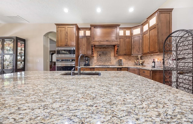 1573 E Commander St, Meridian, ID 83646 - kitchen with stainless steel appliances, tasteful backsplash, a sink, light stone countertops, and recessed lighting