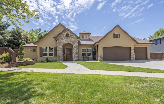 1573 E Commander St, Meridian, ID 83646 - french country home featuring stone siding, stucco siding, concrete driveway, and an attached garage