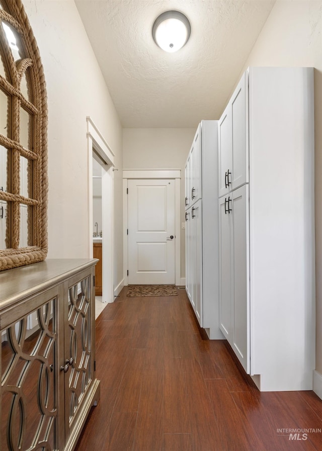1573 E Commander St, Meridian, ID 83646 - hallway featuring a textured ceiling and dark wood-type flooring