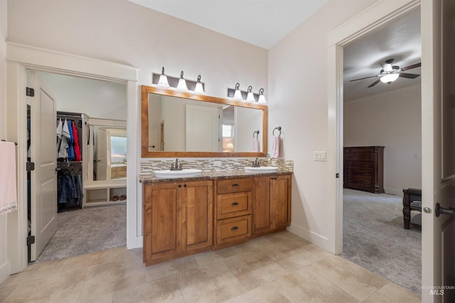 1573 E Commander St, Meridian, ID 83646 - bathroom featuring double vanity, ceiling fan, baseboards, crown molding, and tasteful backsplash