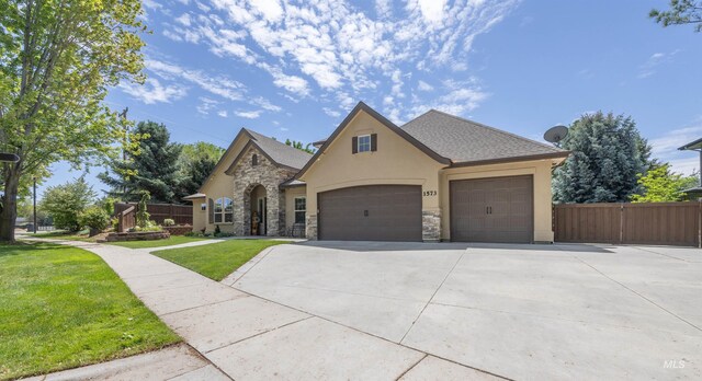 1573 E Commander St, Meridian, ID 83646 - french country home featuring stucco siding, driveway, a garage, and stone siding