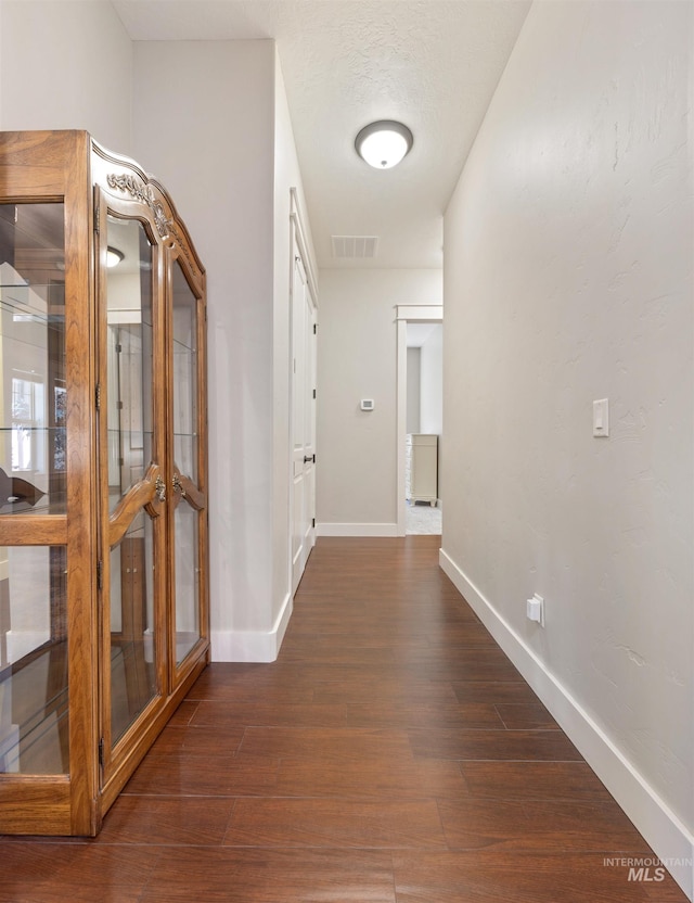 1573 E Commander St, Meridian, ID 83646 - hall featuring dark wood-style floors, baseboards, and french doors