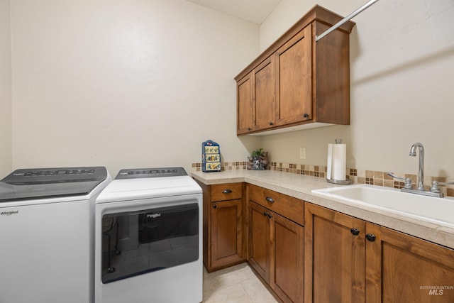 1573 E Commander St, Meridian, ID 83646 - laundry area featuring separate washer and dryer, cabinet space, and light tile patterned floors