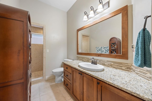 1573 E Commander St, Meridian, ID 83646 - full bathroom with toilet, vanity, a tile shower, decorative backsplash, and tile patterned flooring