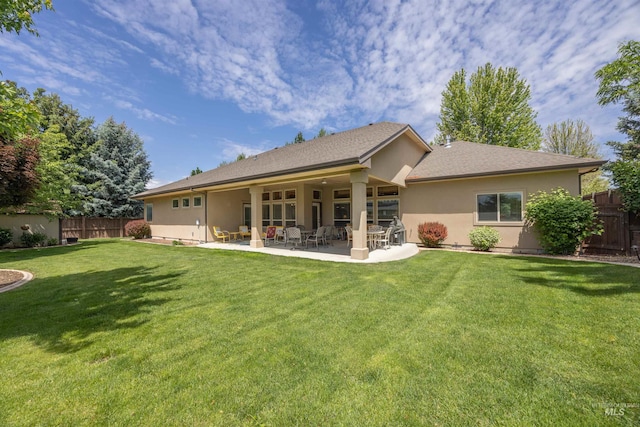 1573 E Commander St, Meridian, ID 83646 - rear view of property with stucco siding and a patio area