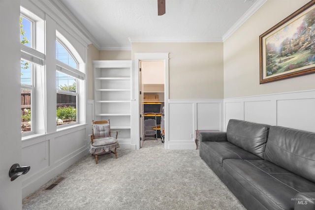 1573 E Commander St, Meridian, ID 83646 - living room with a decorative wall, crown molding, carpet, ceiling fan, and a wainscoted wall