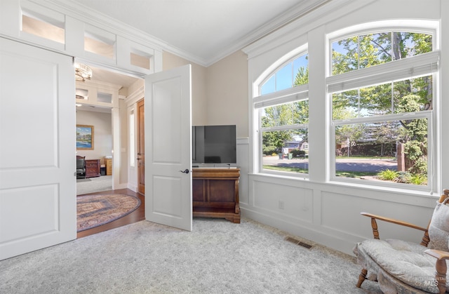 1573 E Commander St, Meridian, ID 83646 - living area featuring light carpet, ornamental molding, and a decorative wall
