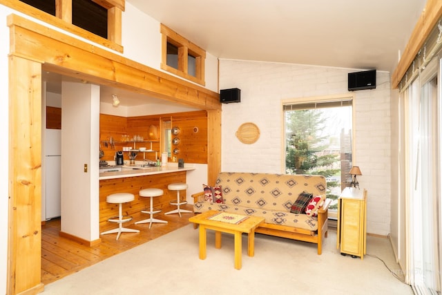 260 S 2nd Ave Unit 51, Ketchum, ID 83340 - living room with wood finished floors, lofted ceiling, and brick wall