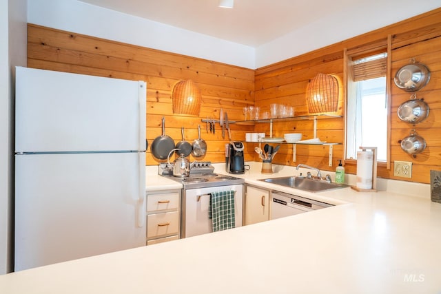 260 S 2nd Ave Unit 51, Ketchum, ID 83340 - kitchen featuring freestanding refrigerator, a sink, wooden walls, light countertops, and range with electric stovetop