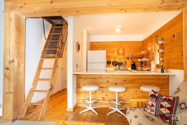 260 S 2nd Ave Unit 51, Ketchum, ID 83340 - bar with freestanding refrigerator, stairway, and hardwood / wood-style floors
