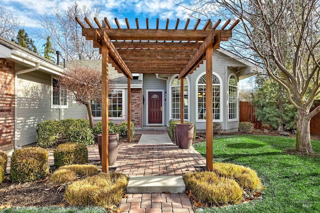 doorway to property with a pergola and a yard