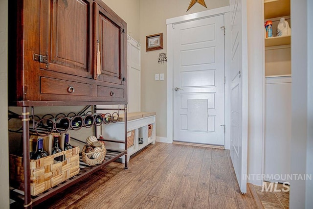 doorway to outside featuring light wood-style floors and baseboards