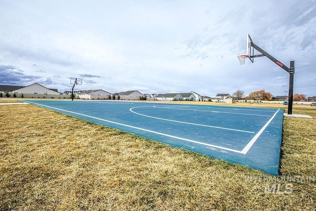 view of sport court featuring community basketball court and a yard