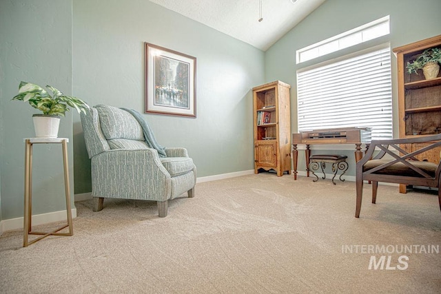 sitting room featuring high vaulted ceiling, baseboards, and carpet flooring