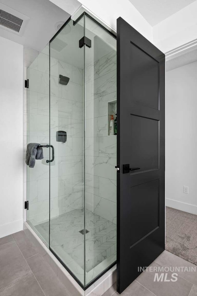 bathroom featuring tile patterned flooring and walk in shower