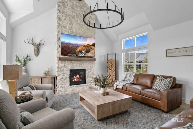 living room featuring hardwood / wood-style floors, a stone fireplace, and high vaulted ceiling