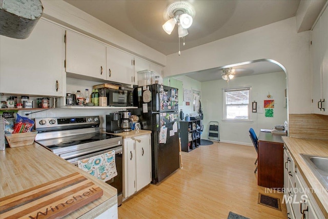 kitchen with black appliances, light countertops, light wood-style flooring, white cabinetry, and a ceiling fan