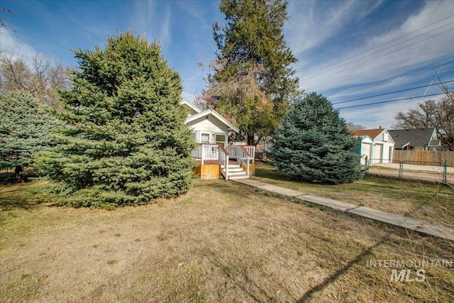 view of yard with a wooden deck and fence