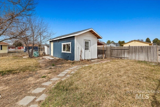 view of outdoor structure featuring an outbuilding and a fenced backyard