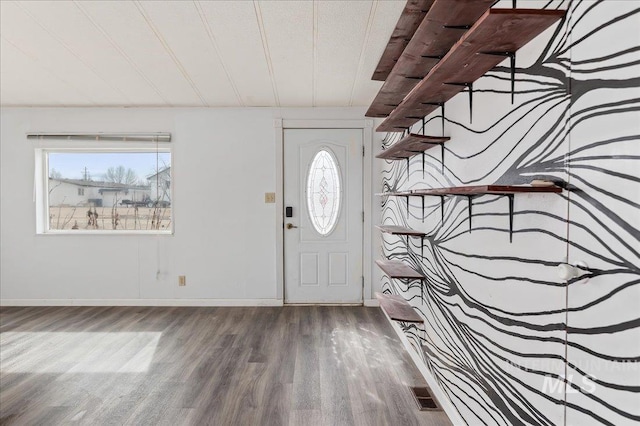 foyer with wood finished floors, a healthy amount of sunlight, visible vents, and baseboards