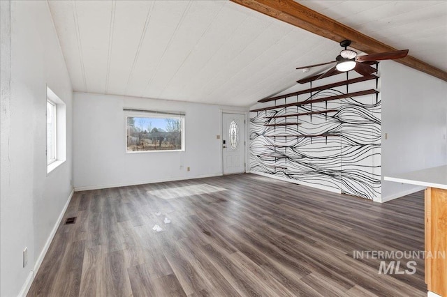 unfurnished living room with baseboards, a ceiling fan, wood finished floors, and vaulted ceiling with beams