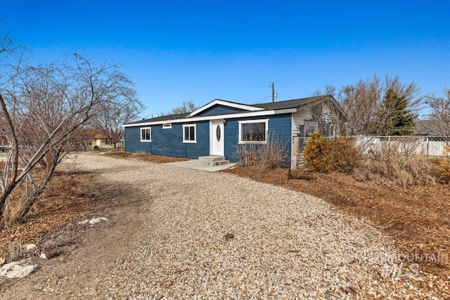 ranch-style house featuring fence